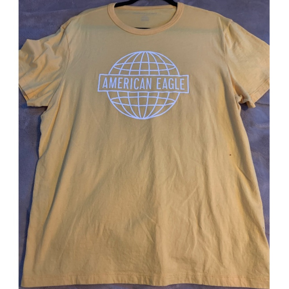 A yellow American eagle shirt